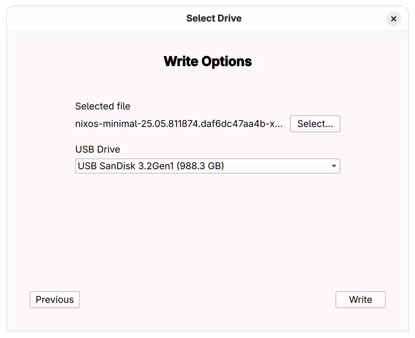 Writing the image A dialog for choosing "Write Options" at Fedora Media Writer. A file named "nixos-minimal-25.05.811874.daf6dc47aa4b-x86_64-linux.iso" is selected, and "USB SanDisk 3.2Gen1 (988.3 GB)" is selected as a USB Drive.