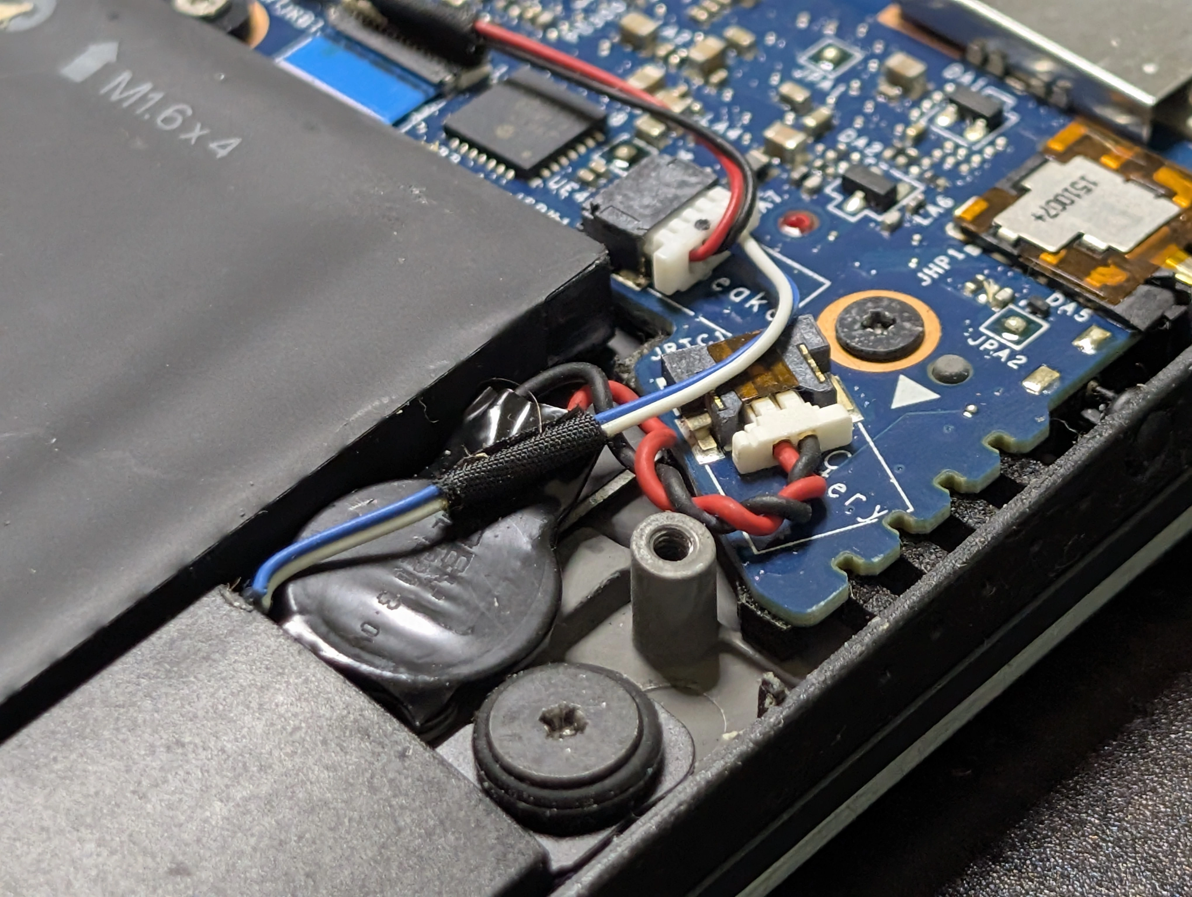 The RTC battery, next to the main battery, plugged in to the mainboard
